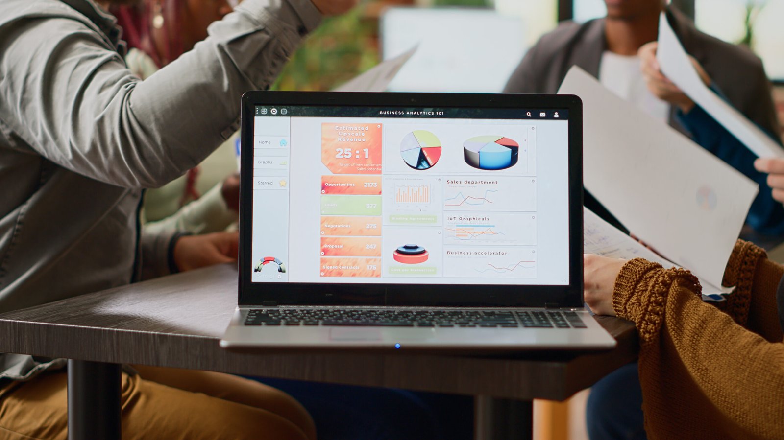 multiethnic group coworkers analyzing business charts infographics data laptop software people doing teamwork collaboration create paper reviews professional report close up